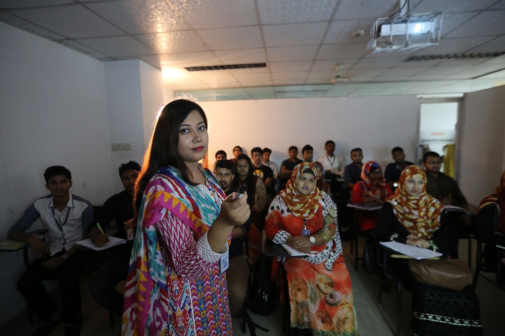 Teacher giving lecture with multimedia projector.JPG